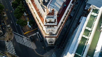 Naklejka premium Aerial top down view on old building next to modern one during golden hour (sunset time) with no people or traffic due to corona virus quarantine - 24 March 2020