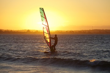 windsurfer on the beach at sunset. Rio de Janeiro, Brazil
