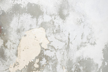 gray wall of old house closeup. White peeling plaster. Cracks on the surface of building or fence. City building concept. Copy space. Place for text. Selective focus image.