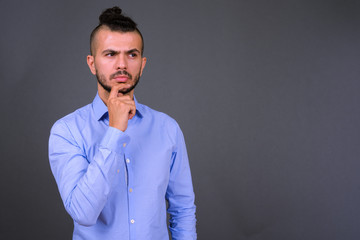 Portrait of serious bearded Turkish businessman thinking