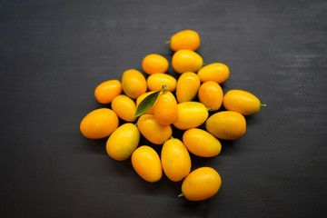 Kumquats on a black background
