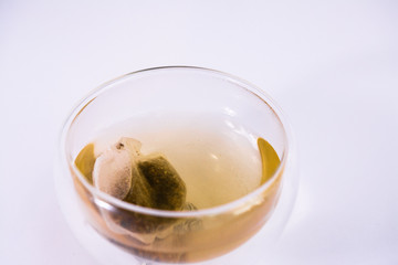 tea in a transparent glass, on a white background