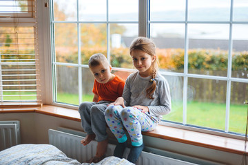 children on sill at window