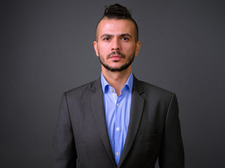 Face of handsome bearded Turkish businessman in suit