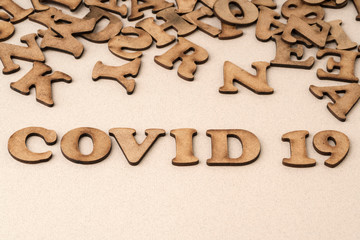 Epidemic corona virus covid 19 written with wooden letters