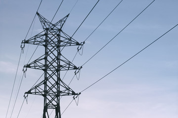 Power line against the blue sky. Energy, electricity, communication. High-voltage tower, line