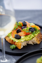 Toast with avocado, sicilian orange and olives