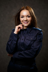Fototapeta premium portrait of a beautiful girl in police uniform. Professional posing