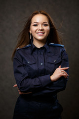 portrait of a beautiful girl in police uniform. Professional posing