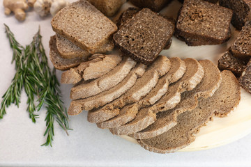 Different varieties of bread on the kitchen table on a light background top view