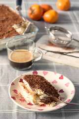 Traditional Italian tiramisu cake flavoured with coffee and topped with chocolate and cocoa