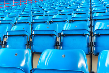Fototapeta premium empty bleachers and chairs in blue