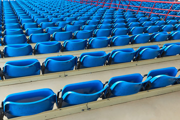 empty bleachers and chairs in blue