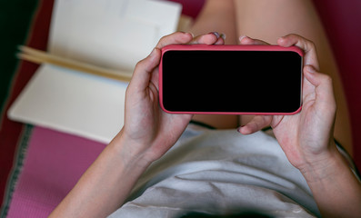 Young woman using smartphone working at home.