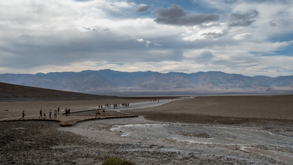 tourist people strolling at badwater basin in the death valley desert