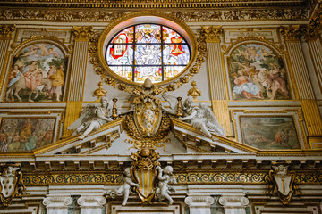 Fototapeta premium Rich ornate interior detail of church, golden decoration of the walls.