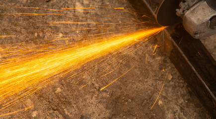 Sparks from sawing metal at a construction site