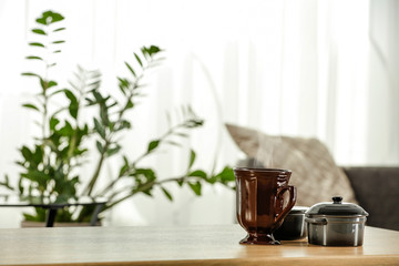 Spring time and wooden desk in home interior with blurred window. 