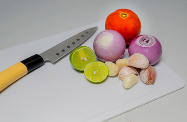 Set of bright vegetables around on white cutting board. Free space for text