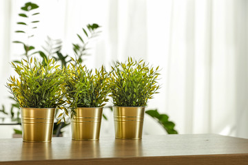 Spring time and wooden desk in home interior with blurred window. 