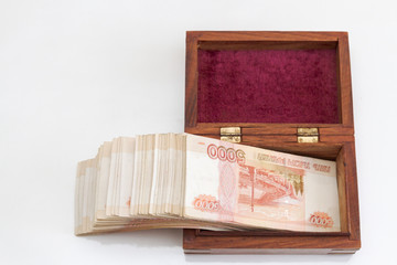 Russian banknotes of five thousand rubles in large quantities in a wooden box