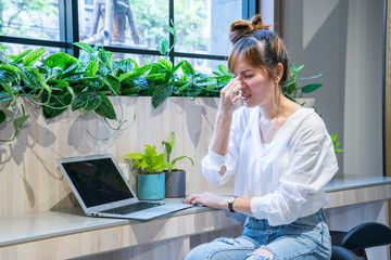 Asian girls feel sick, have a nose pain, have difficulty breathing, start to get infected. While working at home with laptop. - Powered by Adobe