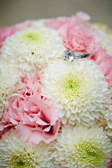 Pink carnation and white chrysanthemum bouquet with ring