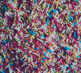 Fototapeta na wymiar colorful abstract background texture of sweet sprinkles sugar macro photo