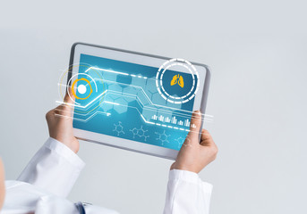 Close of female doctor hands working with tablet pc computer