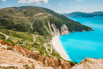 Famous Myrtos Beach at sunny summer day. Tourism visiting destination on Kefalonia island, Greece