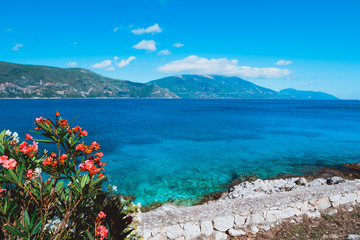 Panorama of crystal clear transparent blue turquoise teal Mediterranean seascape in Fiskardo town. Kefalonia, Ionian islands, Greece