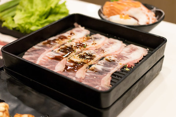 Beef slice on black tray for hot pot or grill (barbecue or yakiniku).