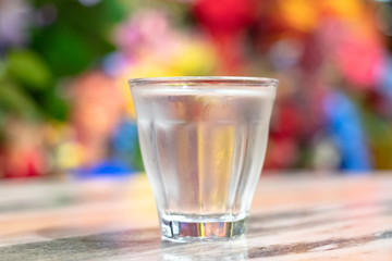 Glass of water with freshness colorful background.