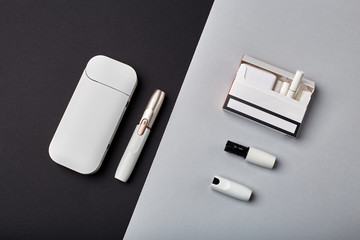 Electronic Cigarette Technology. Tobacco IQOS system. Close-up an electric hybrid cigarette with a...