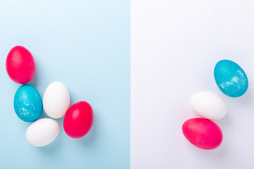 Easter composition with eggs and blank of white paper on blue background. Easter concept. Copy space. Top view