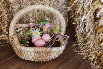Fototapeta na wymiar Happy easter. Basket with easter eggs of pink color. Beautiful decor for Easter, rustic style. Flat lay, top view.