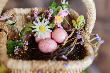 Obraz premium Happy easter. Basket with easter eggs of pink color. Beautiful decor for Easter, rustic style. Flat lay, top view.