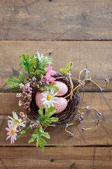  Happy easter. Basket with easter eggs of pink color. Beautiful decor for Easter, rustic style. Flat lay, top view.