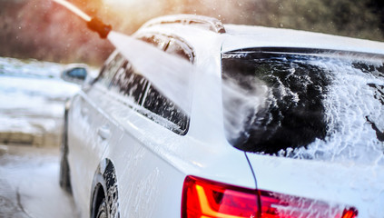 Car Wash Business detail. Washing luxury Car with Copy Space. Wide banner or panorama picture.