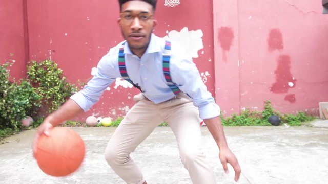 Slow motion young mixed race man outdoor  playing basketball bouncing ball - sportive, relaxing, success concept