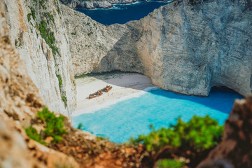 Famous shipwreck on Navagio beach with turquoise blue sea water surrounded by huge white cliffs....