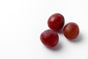 Fototapeta na wymiar Red grape berries on a white background