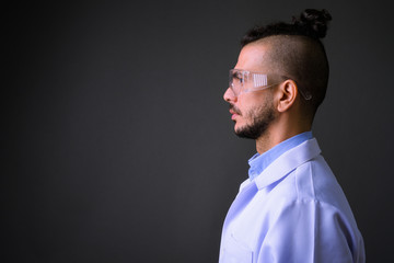 Closeup profile view of handsome bearded Turkish man doctor as scientist