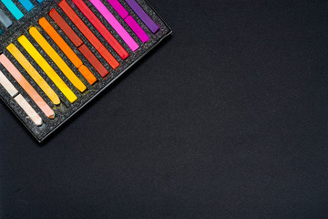 pastel crayons for drawing in a black box on a black background