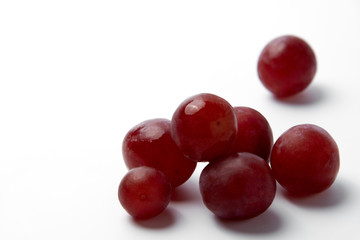Red grape berries on a white background