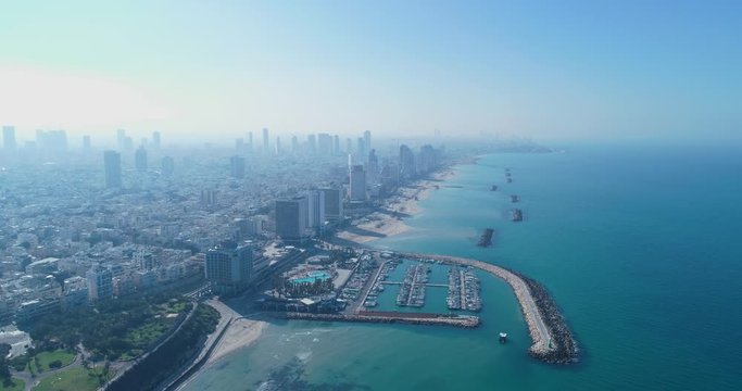 Israel skyline from a drone. Panoramic Aerial view above coastline of Tel Aviv modern and business city with hotels, seashore and beach. Middle east skylines