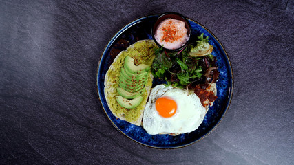 Avocado egg, tomato sauce and fresh salad