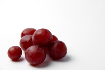 Red grape berries on a white background