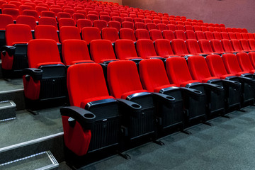 Rows of red velvet seats