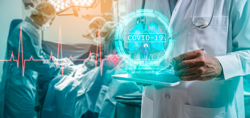 Doctor or Surgeon analyzing covid-19 to patient lungs testing result and human anatomy on technological digital futuristic virtual interface.Doctor with virtual reality in operation room in hospital.